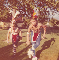 Loinclothed hobby; Obrzek dne - the picture od the day - awa rel -  Skinny boy in indian dance costume on red car in desert - 1950