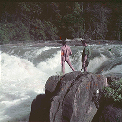 Loinclothed hobby; Obrzek dne - the picture od the day - awa rel -  Colour positive film of Wai Wai person and expedition team member overlooking massive waterfalls