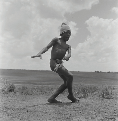 Creator:  Larrabee; Constance Stuart; 1914-2000; Produced:  1941 Phys. Descri  negative : b&w ; 6 x 6 cm. (silver gelatin). photographic print : b&w ; 8 x 10 in. (dupe print).; Subject Geog  South Africa Lesotho   Subjects:  Sotho (Basuto)  Form/Genre  Photographic prints; EEPA 1998-062657; [Summary:  Sotho Herd Boy; 1941. Photographic image of a boy jumping in mid-air. He is wearing a hat and loincloth. Photograph by Constance Stuart Larrabee; 1941. Constance Stuart took photographs in Basutoland (now Lesotho) during her first trip in 1941. In 1947; she returned to Lesotho as an officially accredited photographer. She documented a visit of the British royal family: King George VI; Queen Elizabeth and their daughters Princess Elizabeth and Margaret; to this British Protectorate. She used the occasion to venture into the countryside and captured unique images of rural life among the Sotho people. 
 